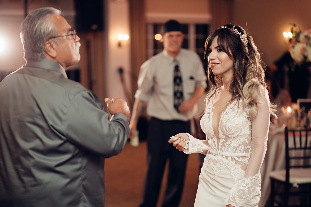 Wedding Photograph Of Bride Speaking To a Man In Gray Suit Los Angeles