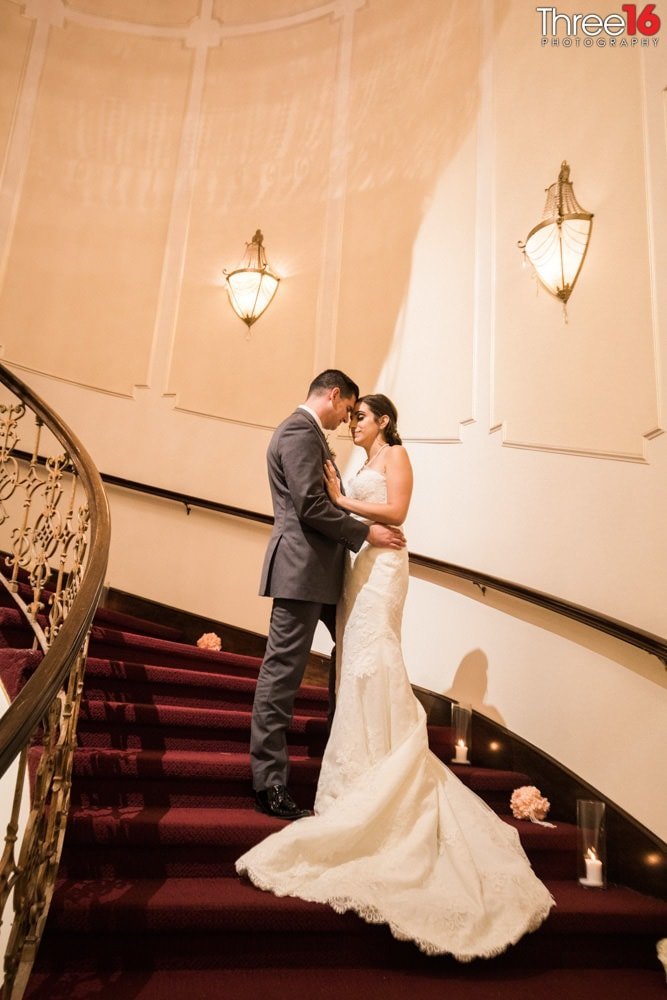 Intimate moment on the stairs between Bride and Groom