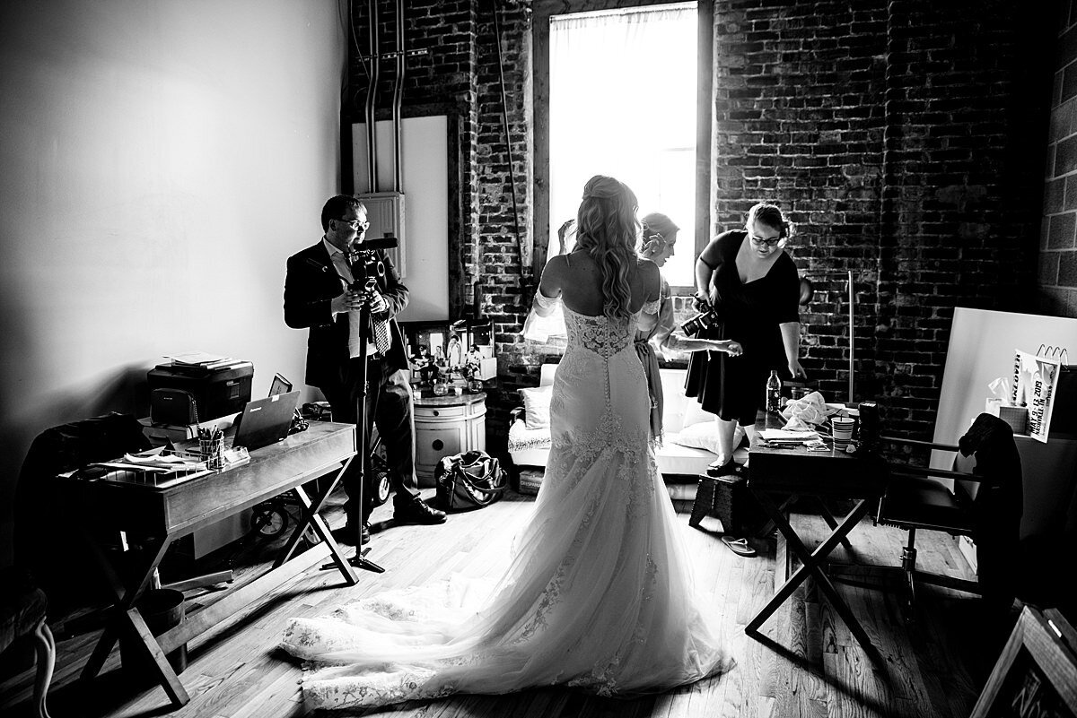 Black and White photo showing behind the scenes with Ivory Door Studio on the wedding day