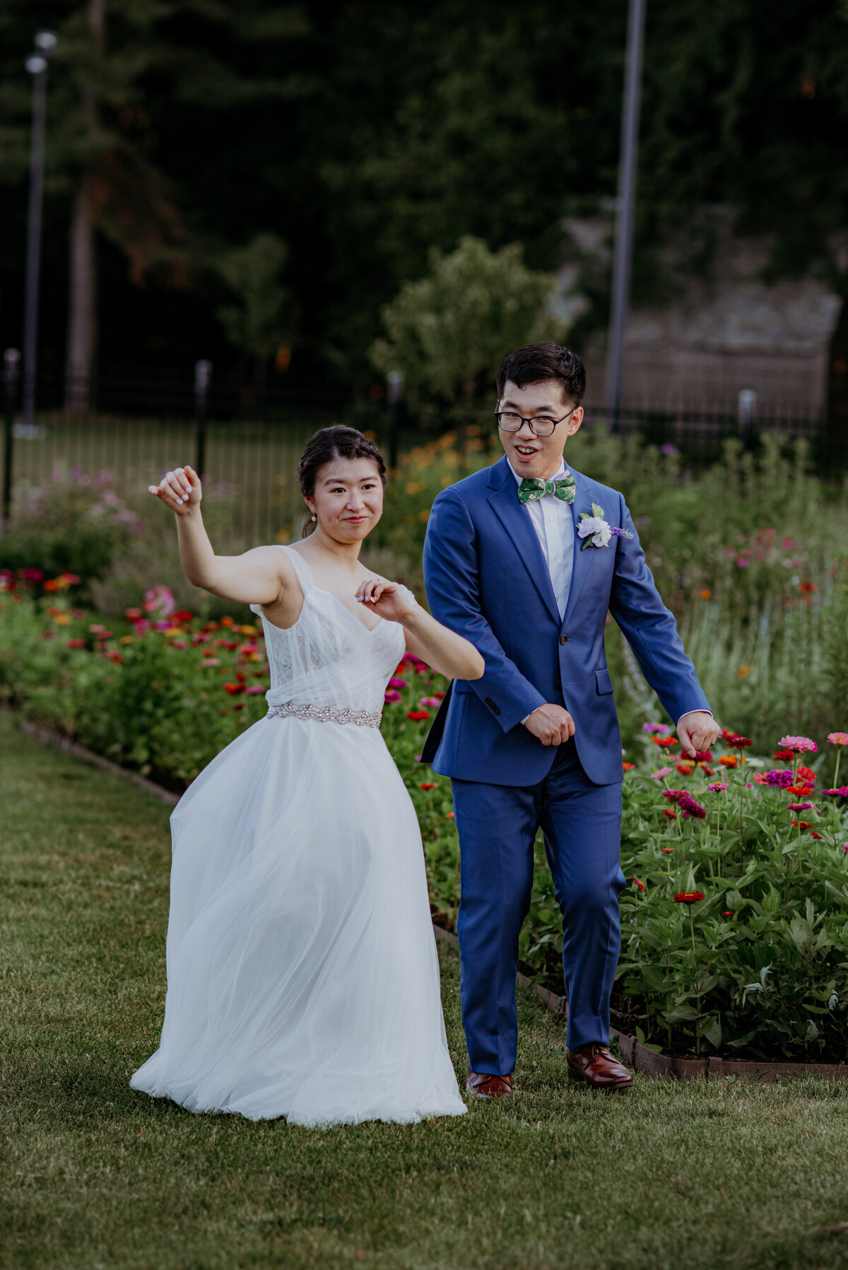A bride and groom dance through the garden of Hartwood Acres during their wedding portraits.