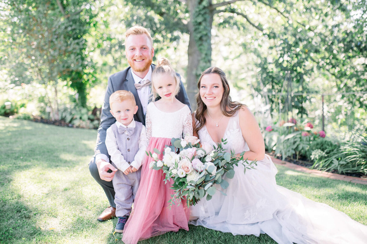 Bride and groom with children at their wedding