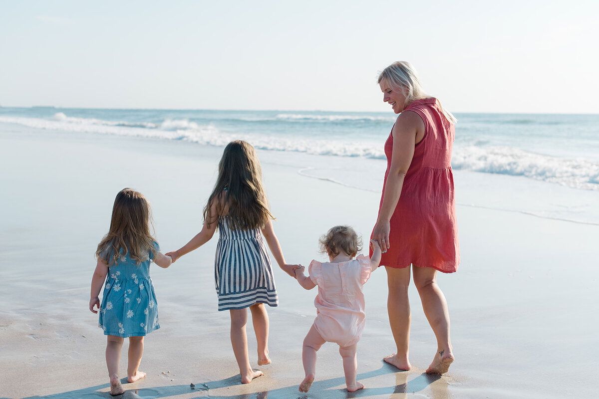 family walks on the beach during their family session in San Diego Califronia