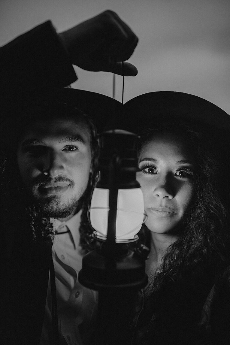 black and white photo of couple  holding a lamp