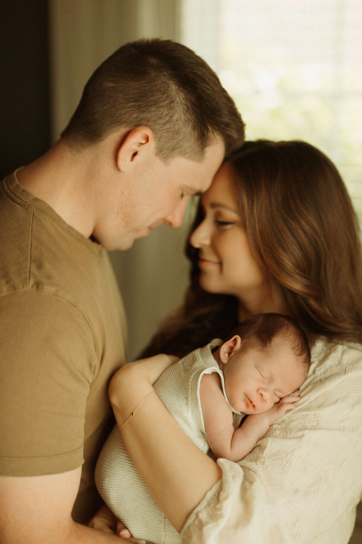 Newborn wrapped in beige swaddle during Franklin Tennessee lifestyle newborn session
