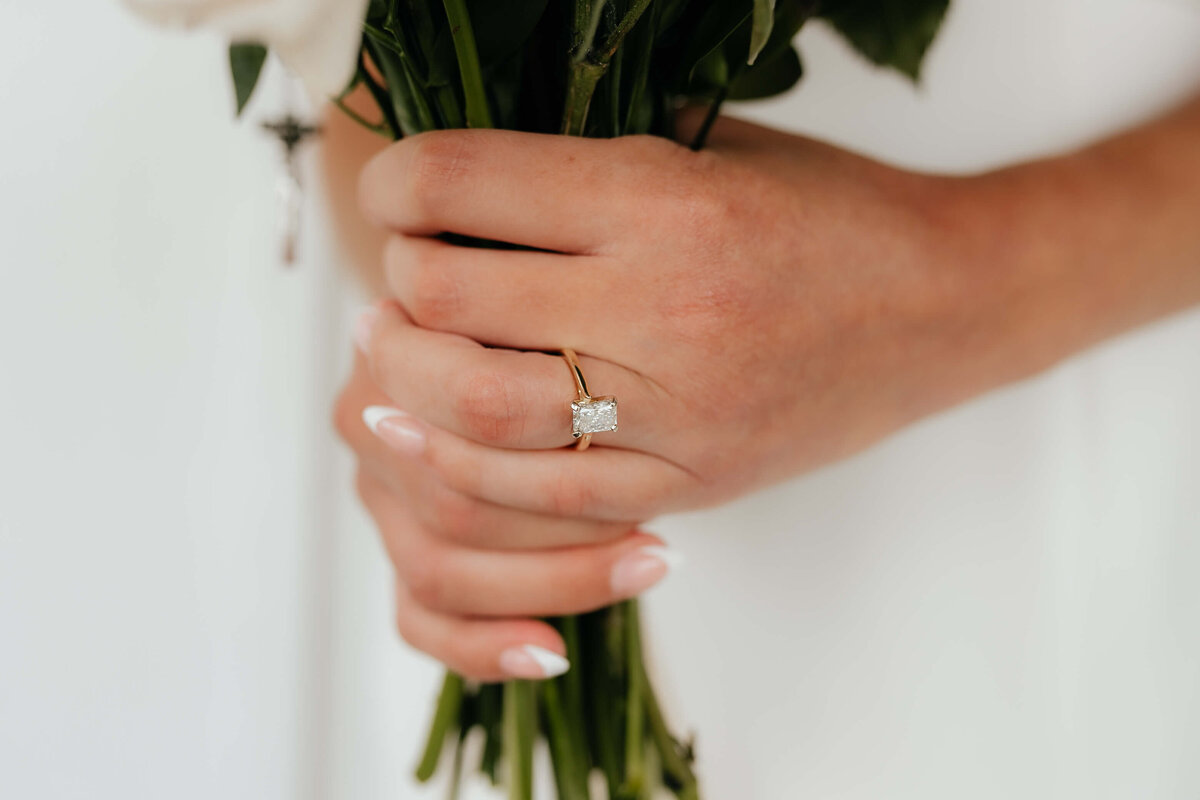 Close-up of gold engagement ring and bouquet, intimate wedding detail photography for Ohio brides who love timeless, elegant moments