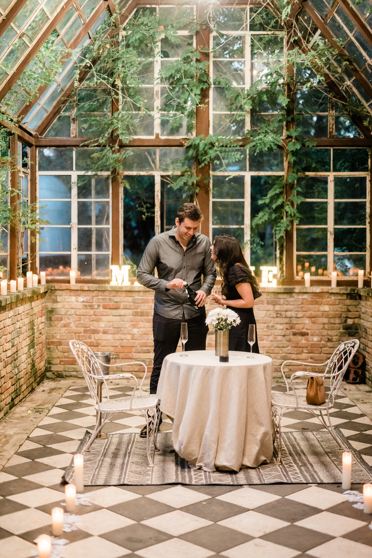 Propose to girlfriend couple opening bottle of champagne