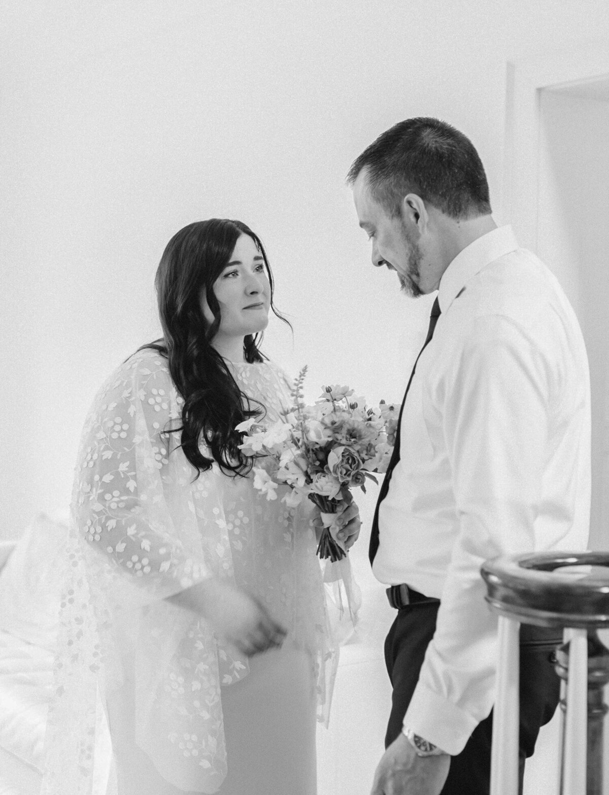 tearful bride gazes at father, candid wedding photographer in Michigan