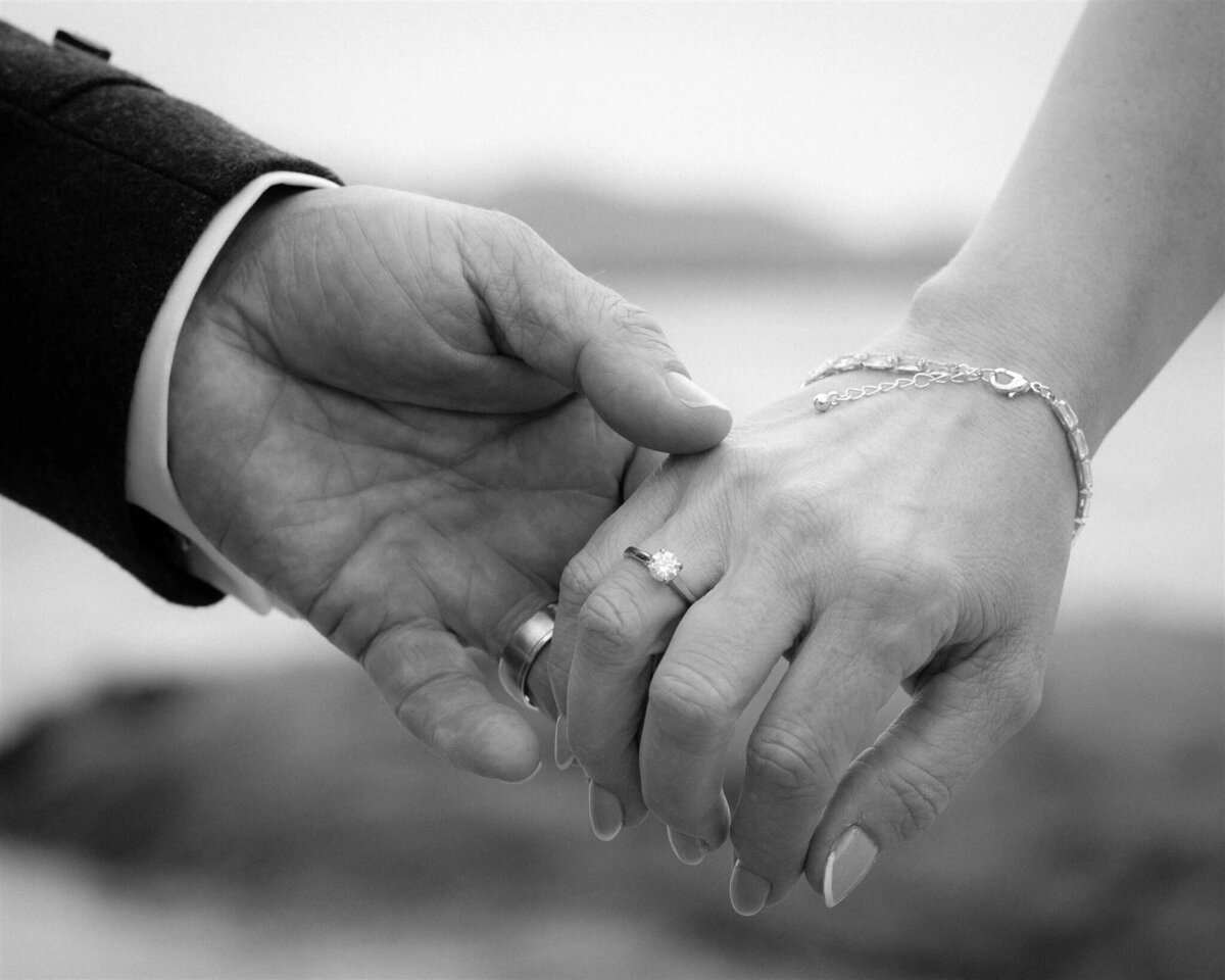 Close up of a bride and grooms hands. Delicately holding.