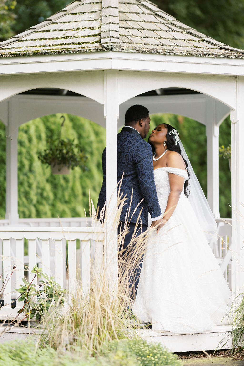 bride and groom standing together under a gazebo