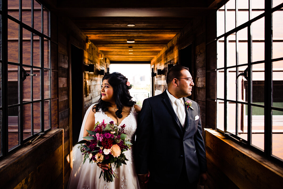One of the top wedding photos of 2020. Taken by Adore Wedding Photography- Toledo, Ohio Wedding Photographers. This photo is of a bride and groom standing side by side looking off in opposite directions in Detroit Michigan