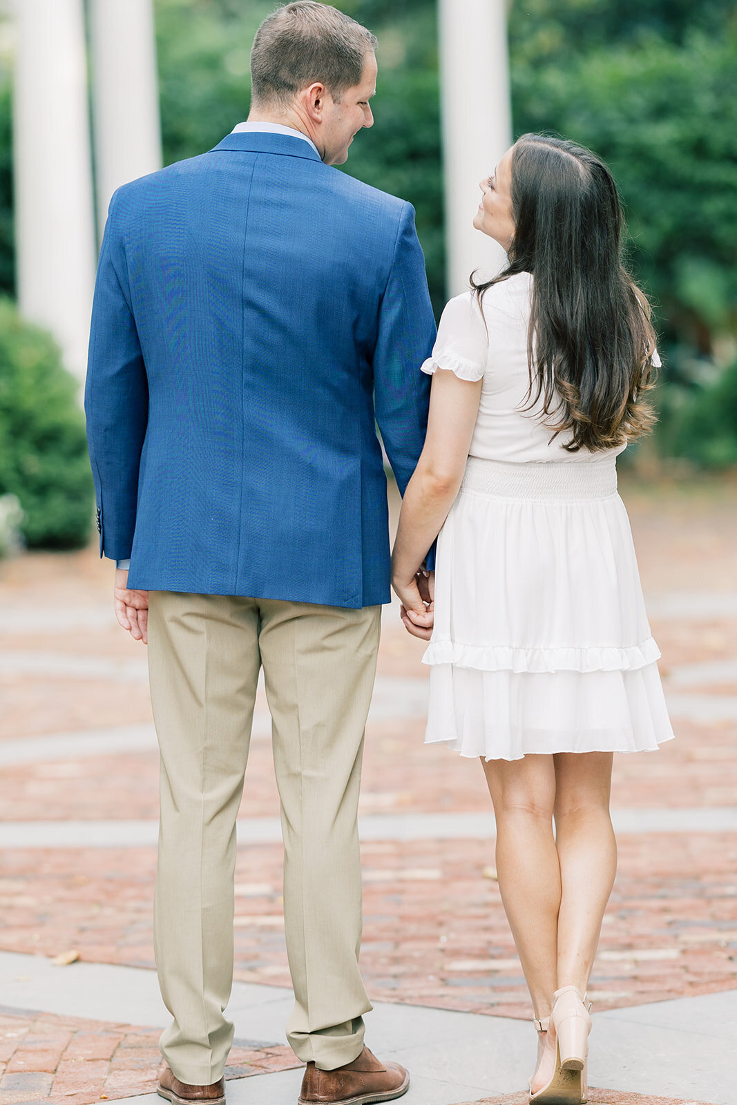 couple-holding-hands-for-engagement-photo
