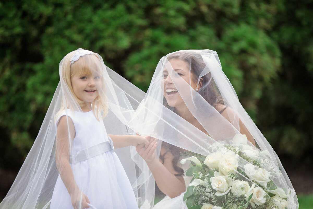 photo of bride with flower girl being silly for wedding at The Carltun