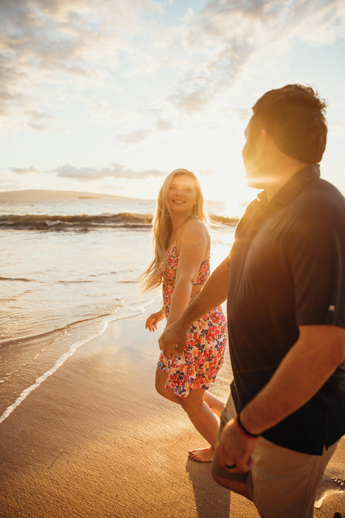 Hawaii Engagement Photographer captures couple walking on beach for sunset portraits