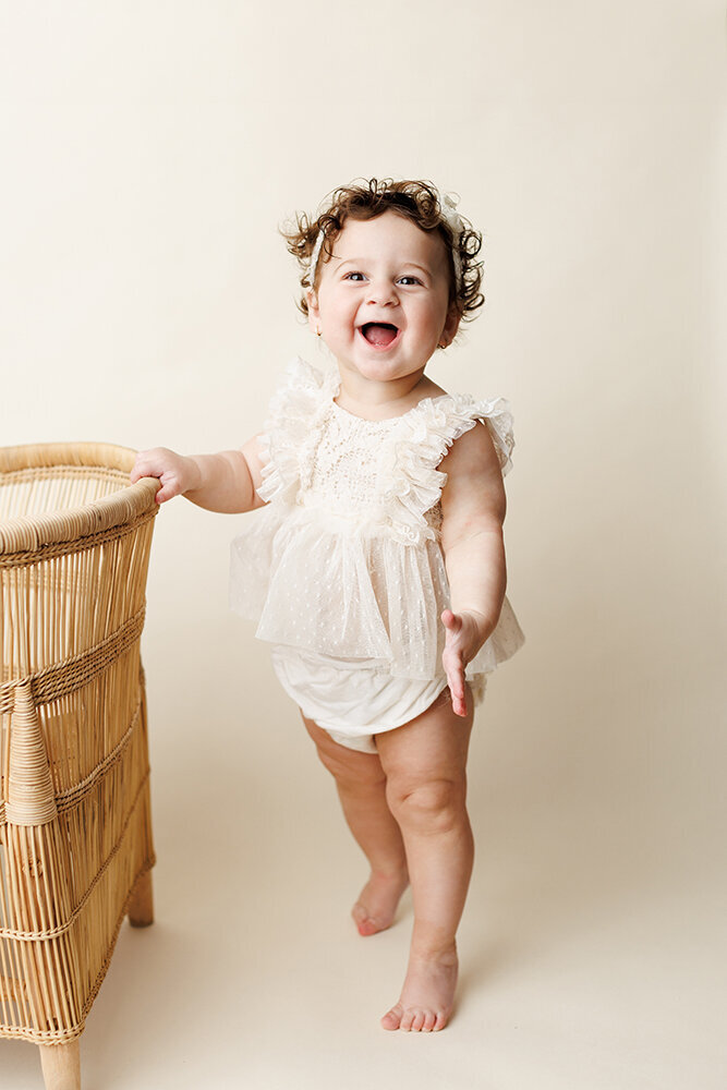 excitedbabystandsbychair