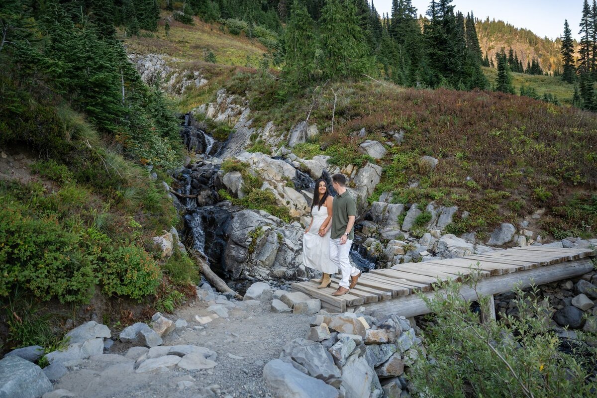 elopement couple mount rainer holding hands on bridge