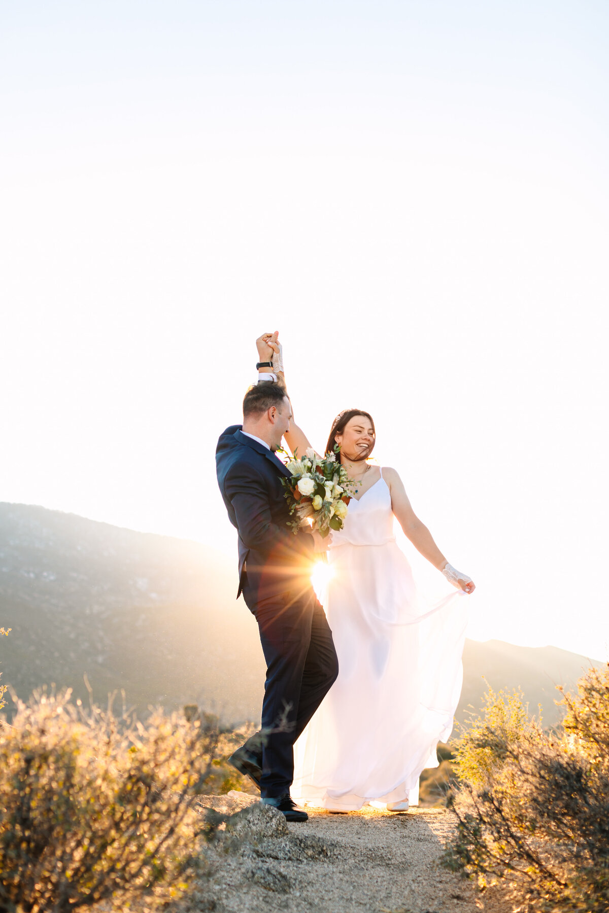 Couples wedding portraits bride groom sunset with sun flare in Idyllwild, CA