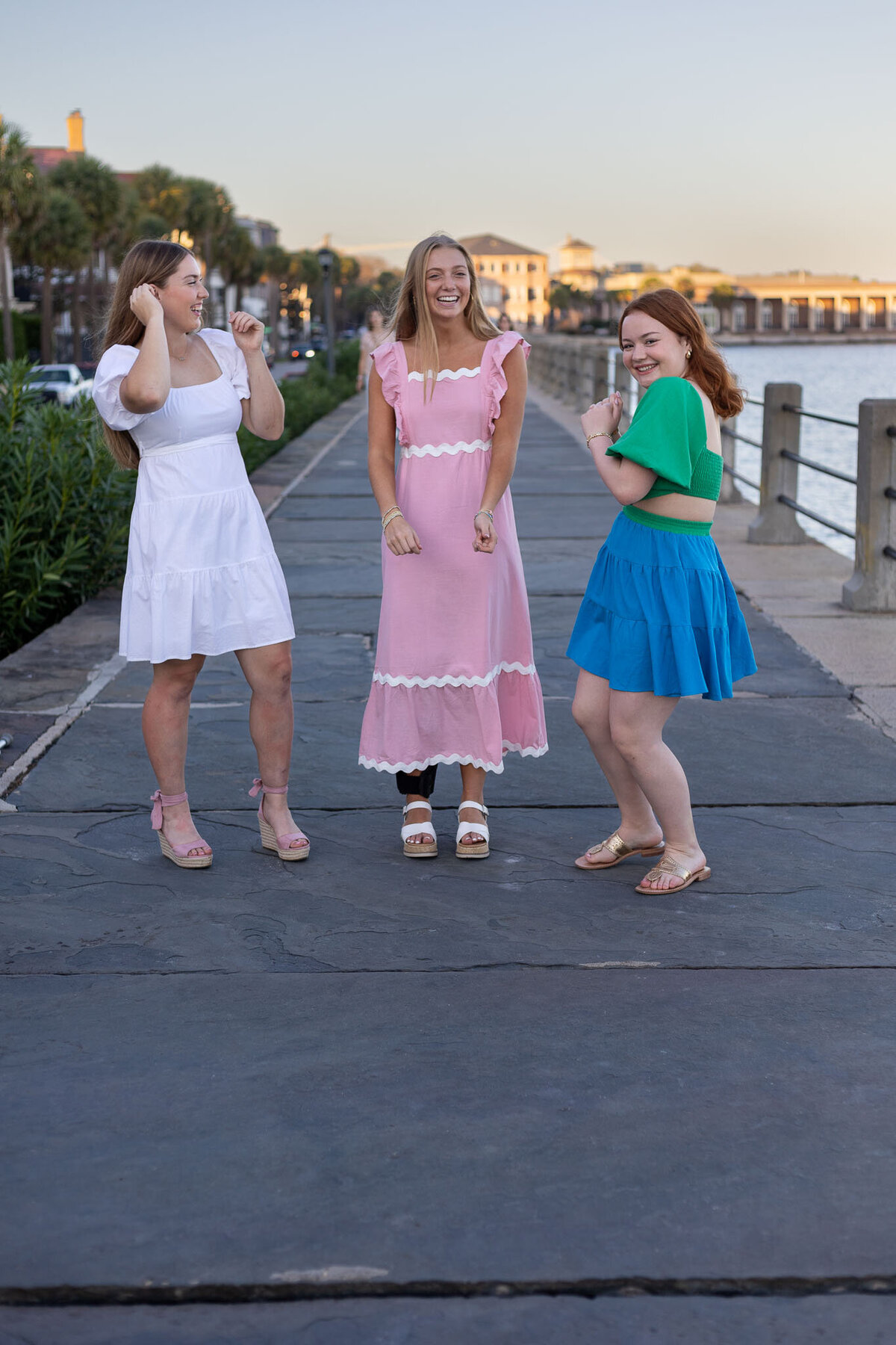 MBP Senior Team dancing on a sidewalk next to the river in Lawrence, KS