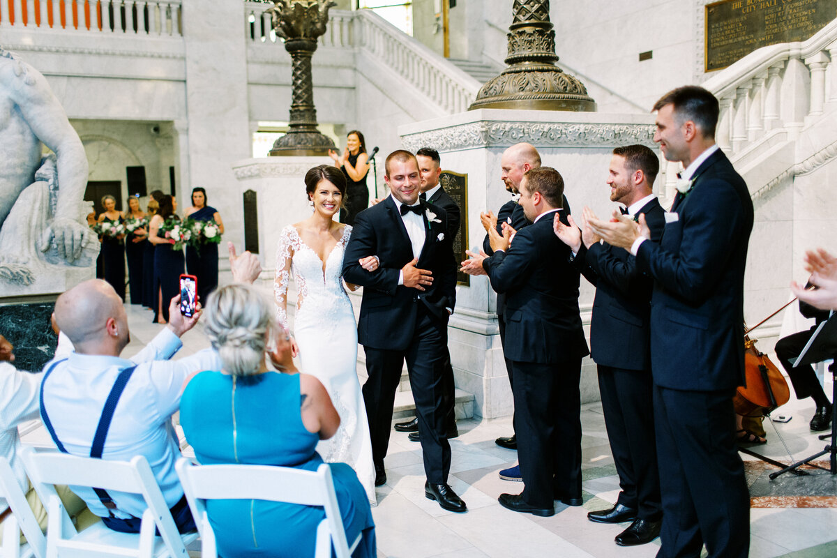 Just married, bride and groom walking out at  Minneapolis city hall wedding