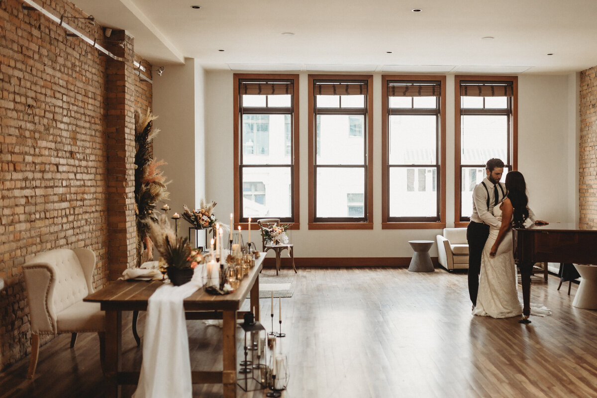 Couple dancing at the indoor wedding reception at The Garret, historical and sophisticated, Calgary, Alberta wedding venue, featured on the Brontë Bride Vendor Guide.