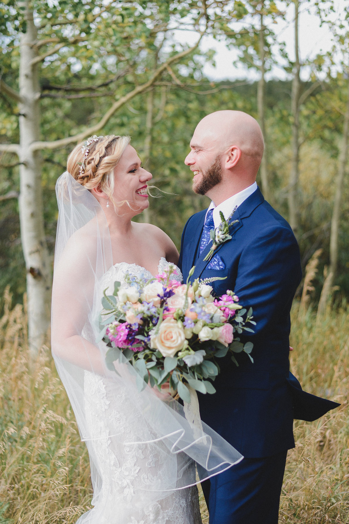 bride and groom portrait with a large pink bouquet