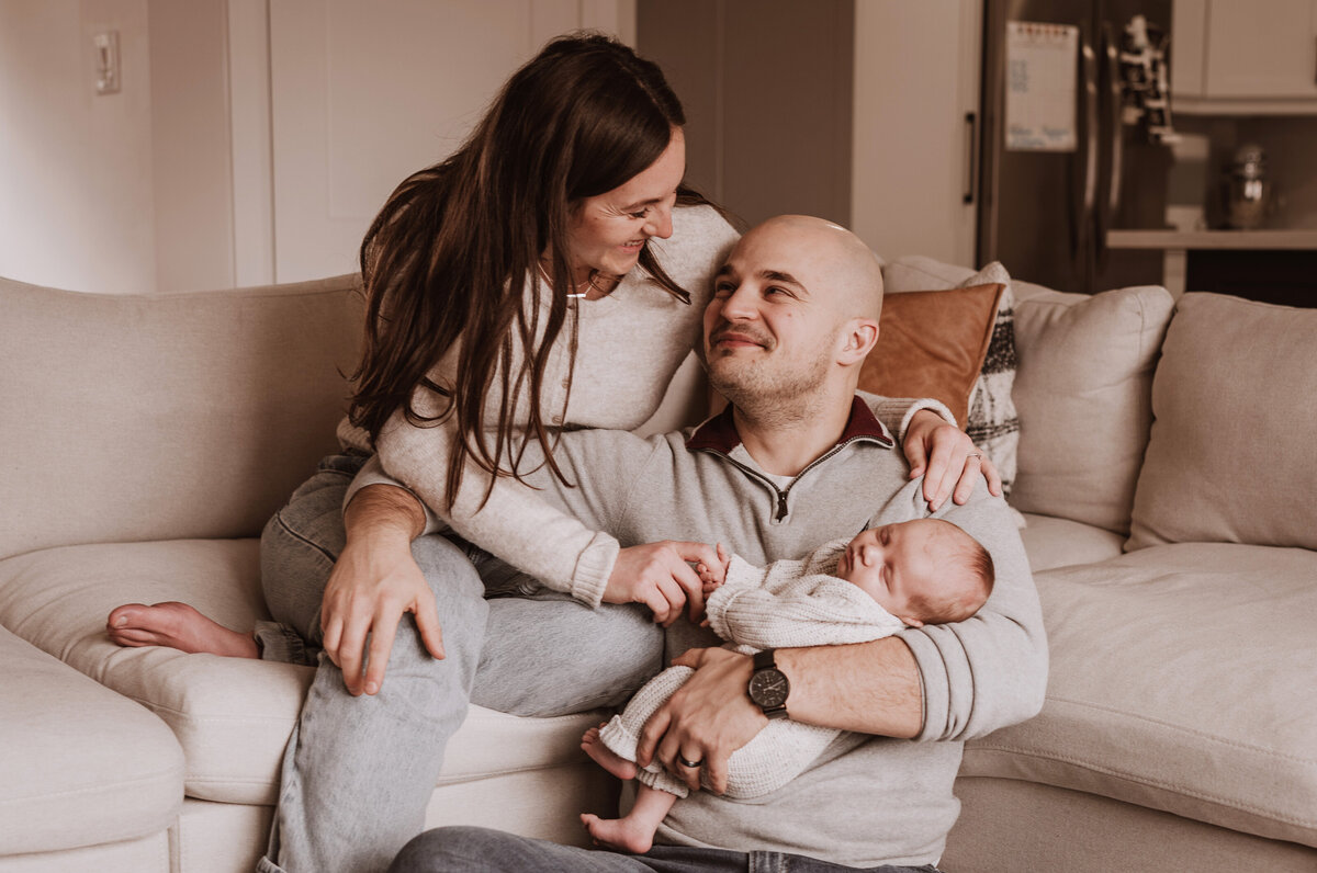 parents embracing with baby