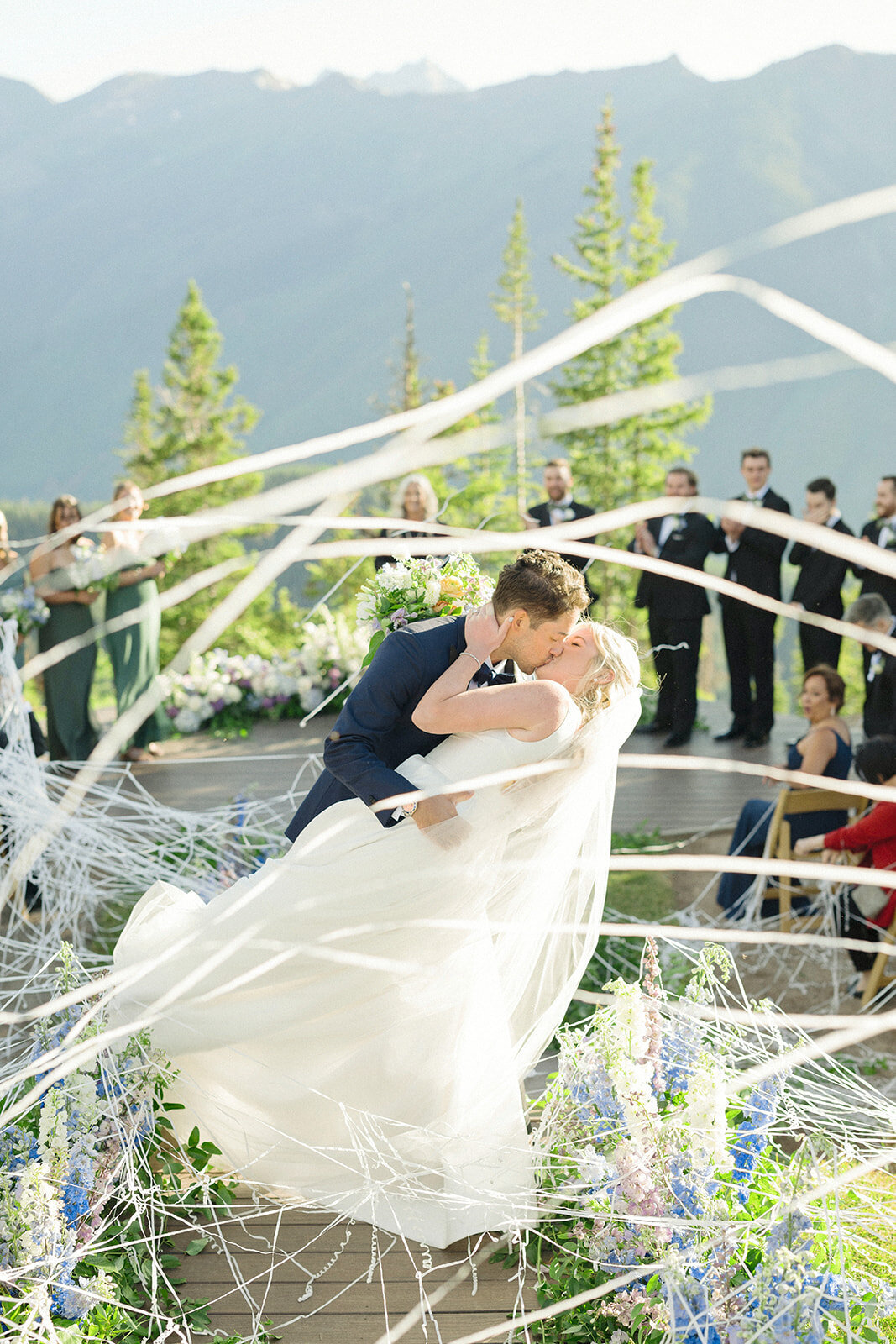 newlyweds-dip-kiss-with-streements-aspen-HBICWeddings