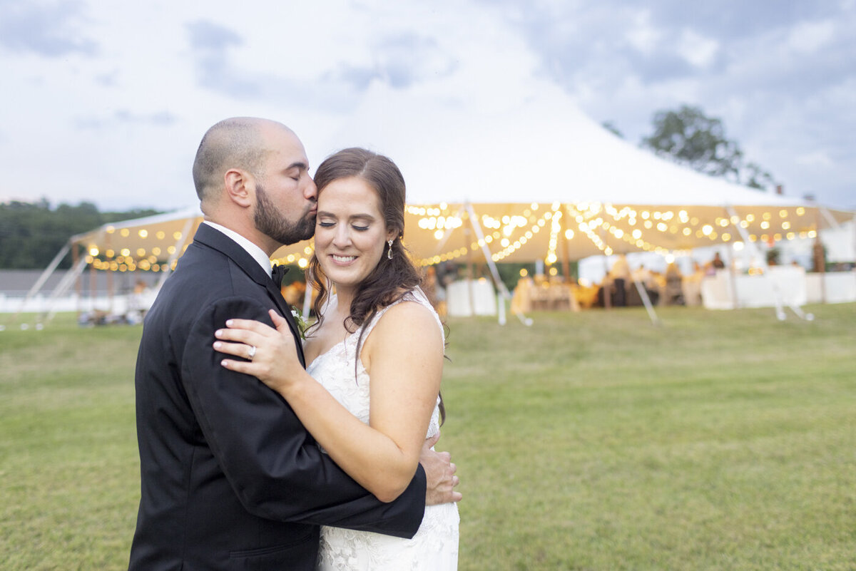 groom kisses bride's head - candlelight farms inn wedding
