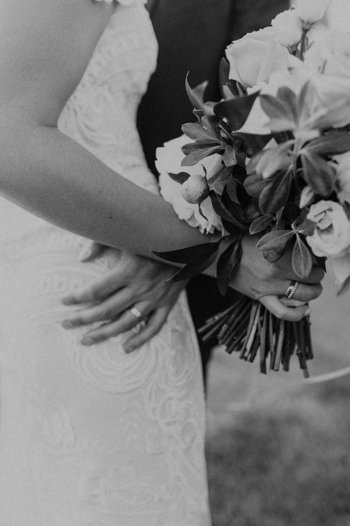 Wedding Detail in Black and White with Brides Bouquet and Grooms Ring