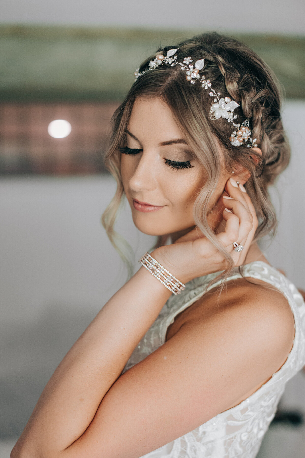 A beautiful bride putting on her diamond earrings
