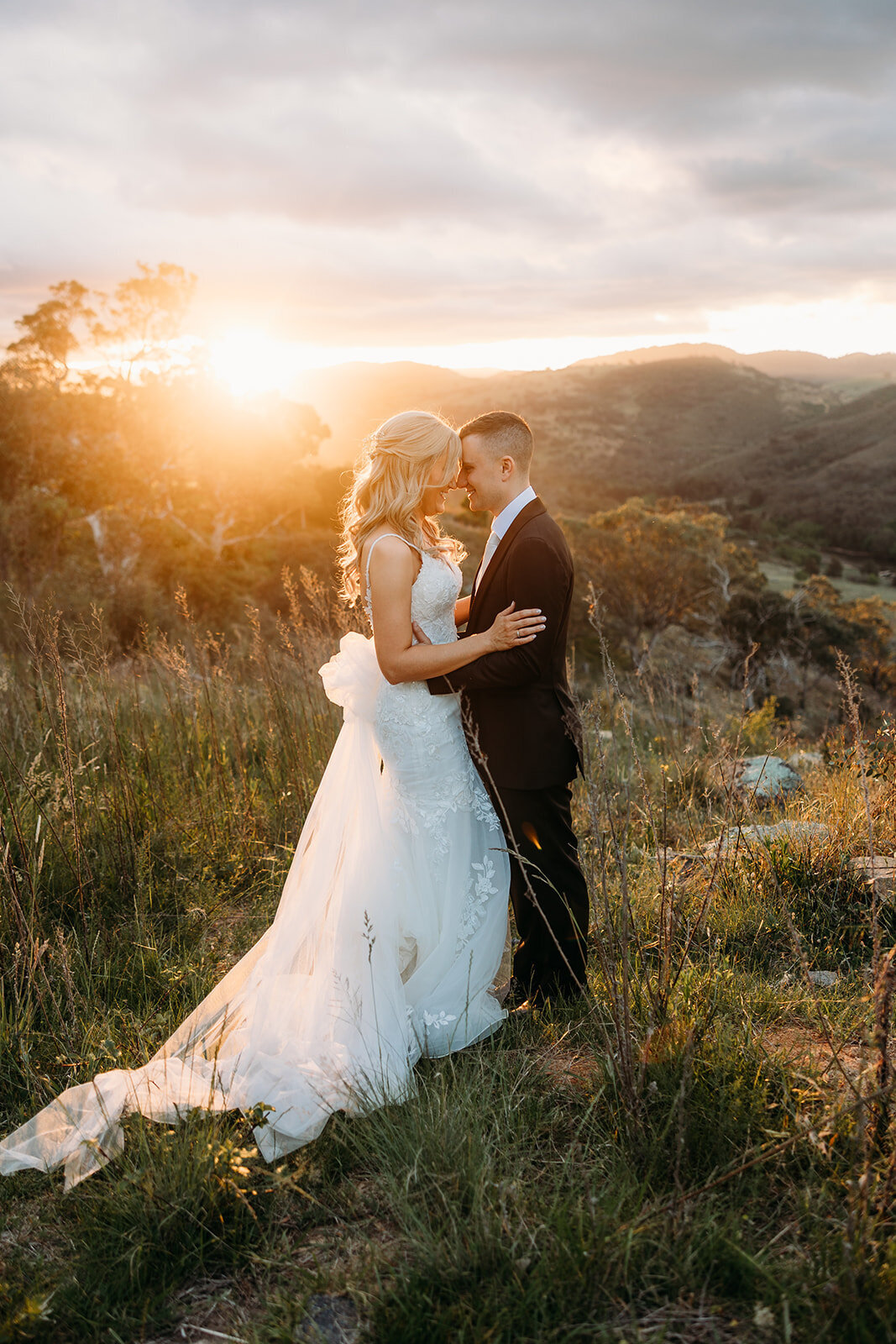 A wedding photo featuring the couple in front of an incredible sunset at Brindabella Hills Winery