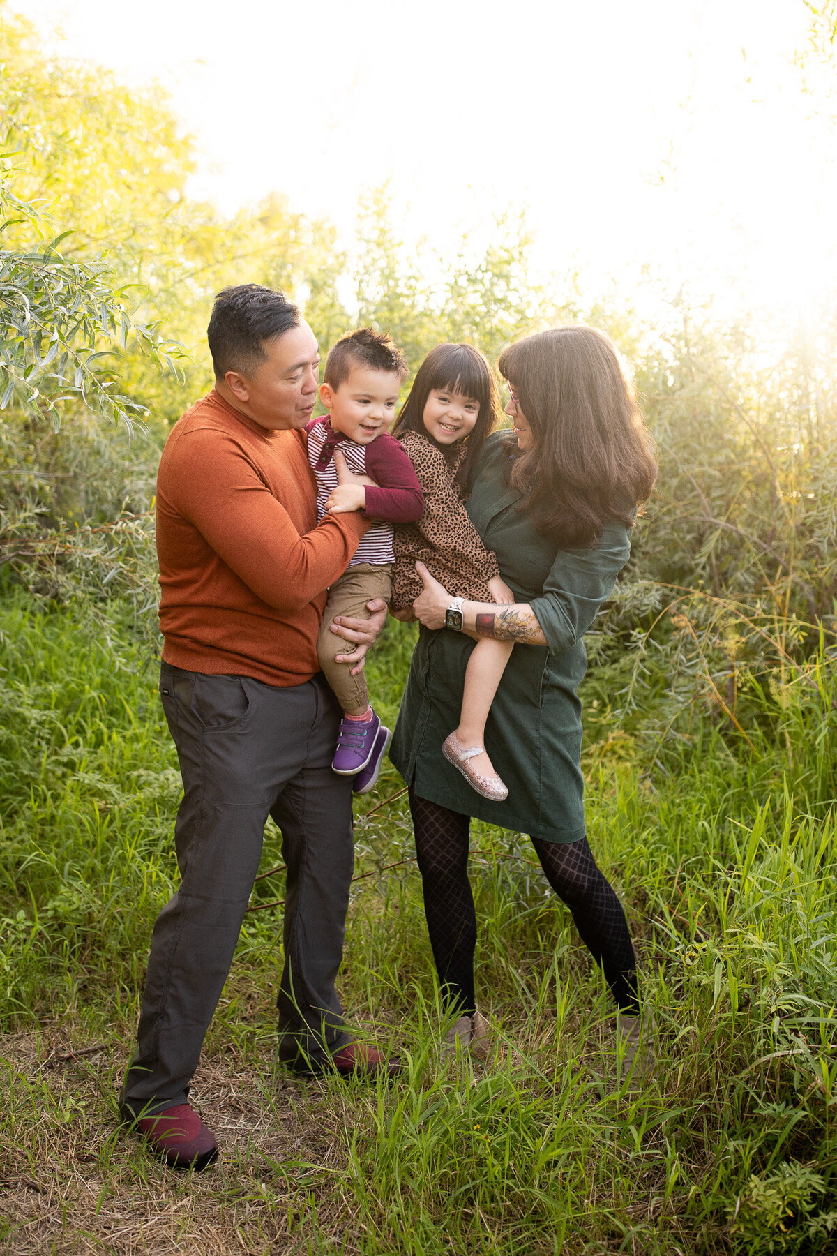 Family standing in lush grass in the columbia river gorge during a Portland family photography session.
