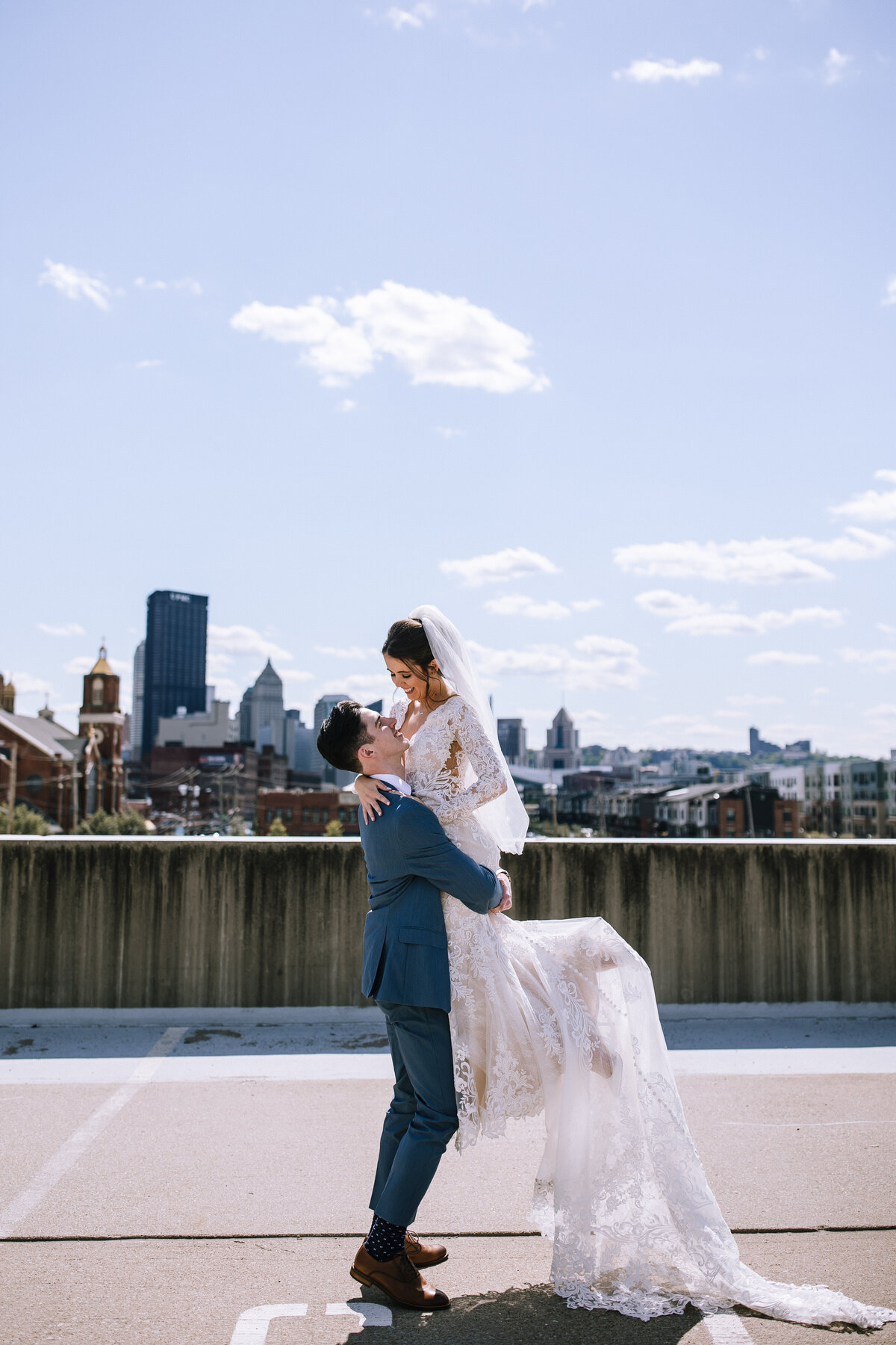 Groom lifting up bride on rooftop in the Pittsburgh strip district.