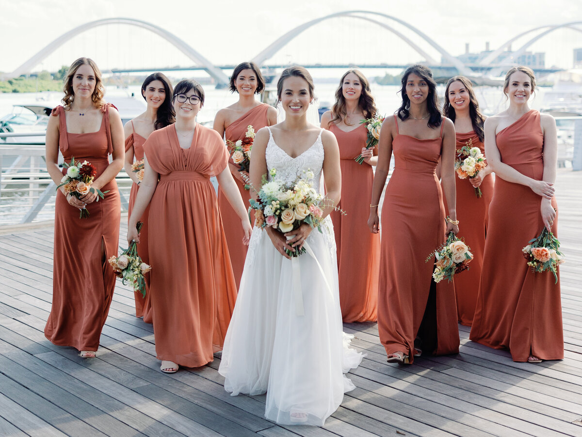 A bride walks with her bridesmaids on the dock of the wharf in washington dc