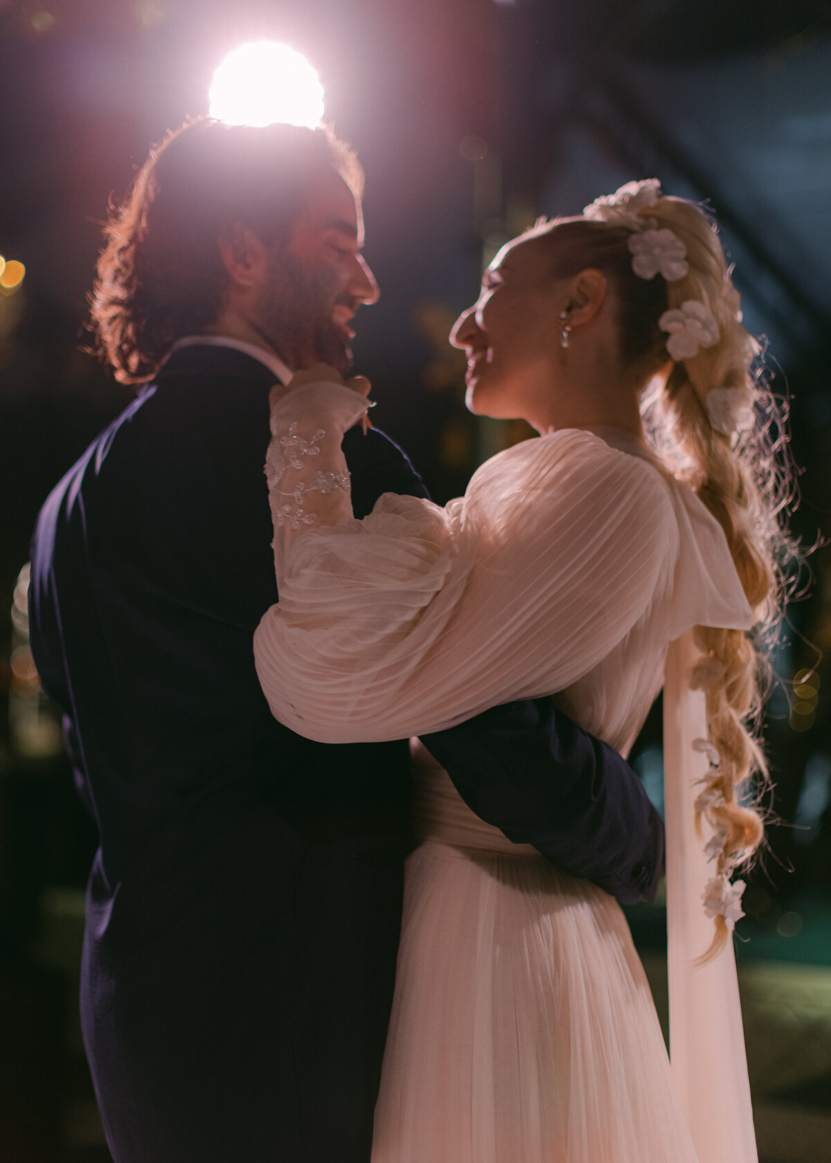 bride and groom with spotlight behind them