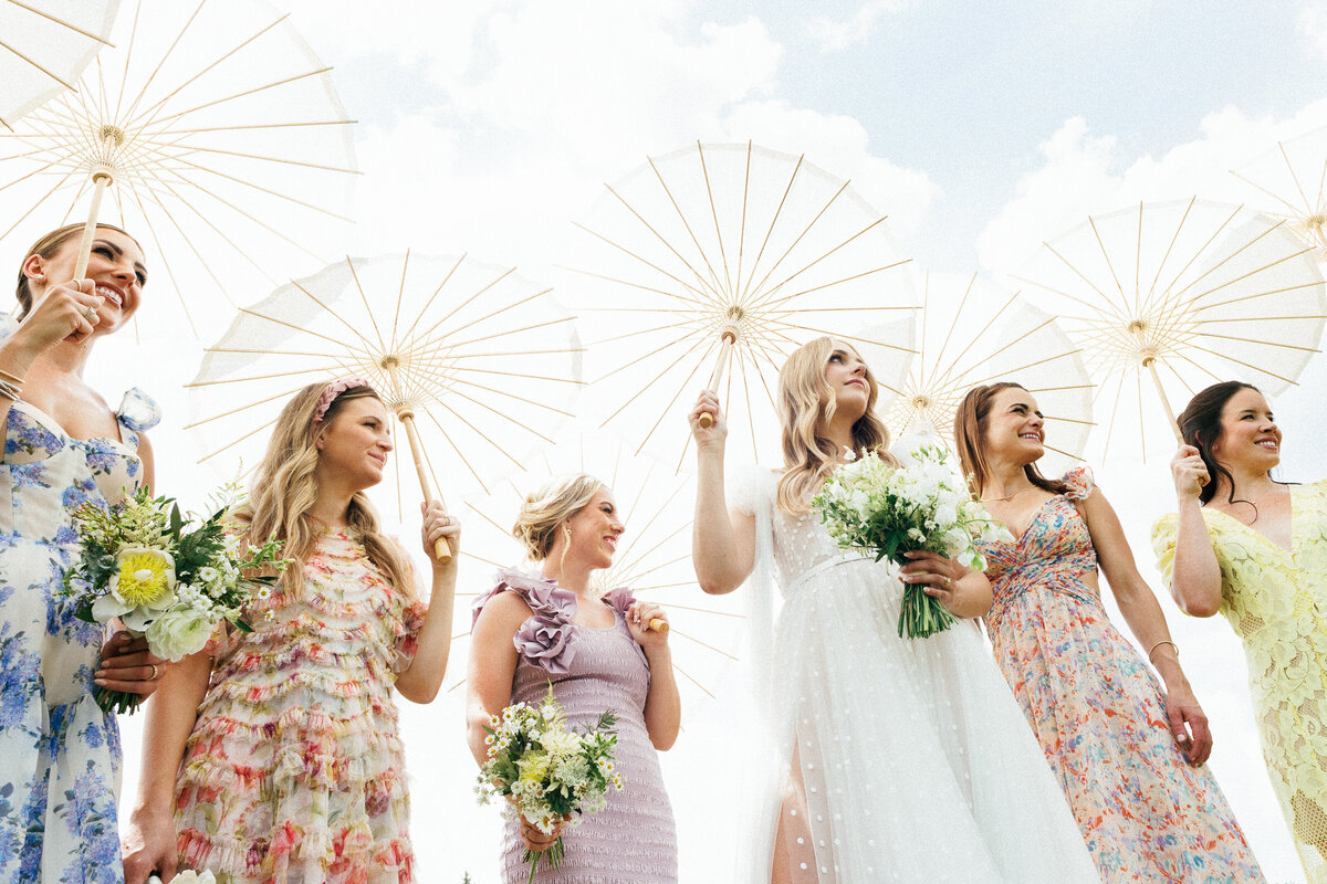 bridesmaids with parasols on wedding day floral