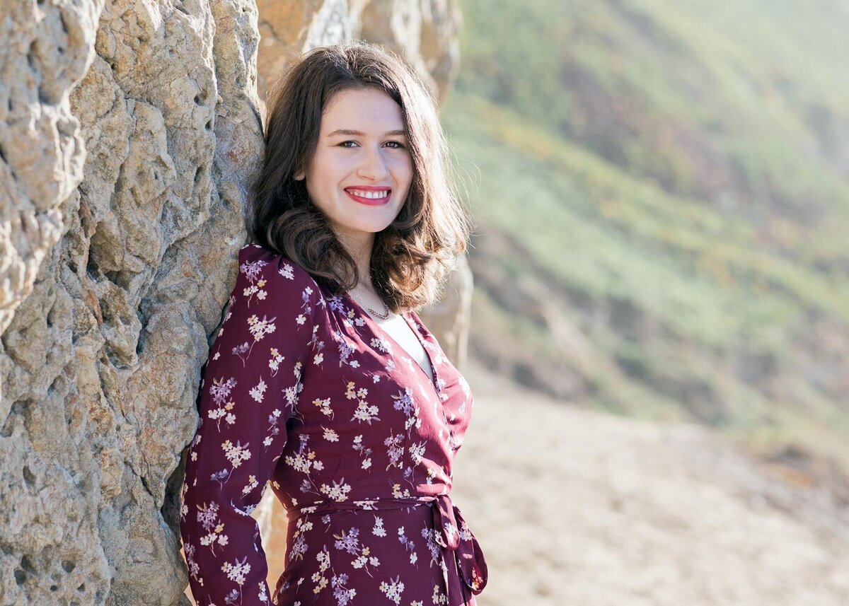 senior portrait by stone wall