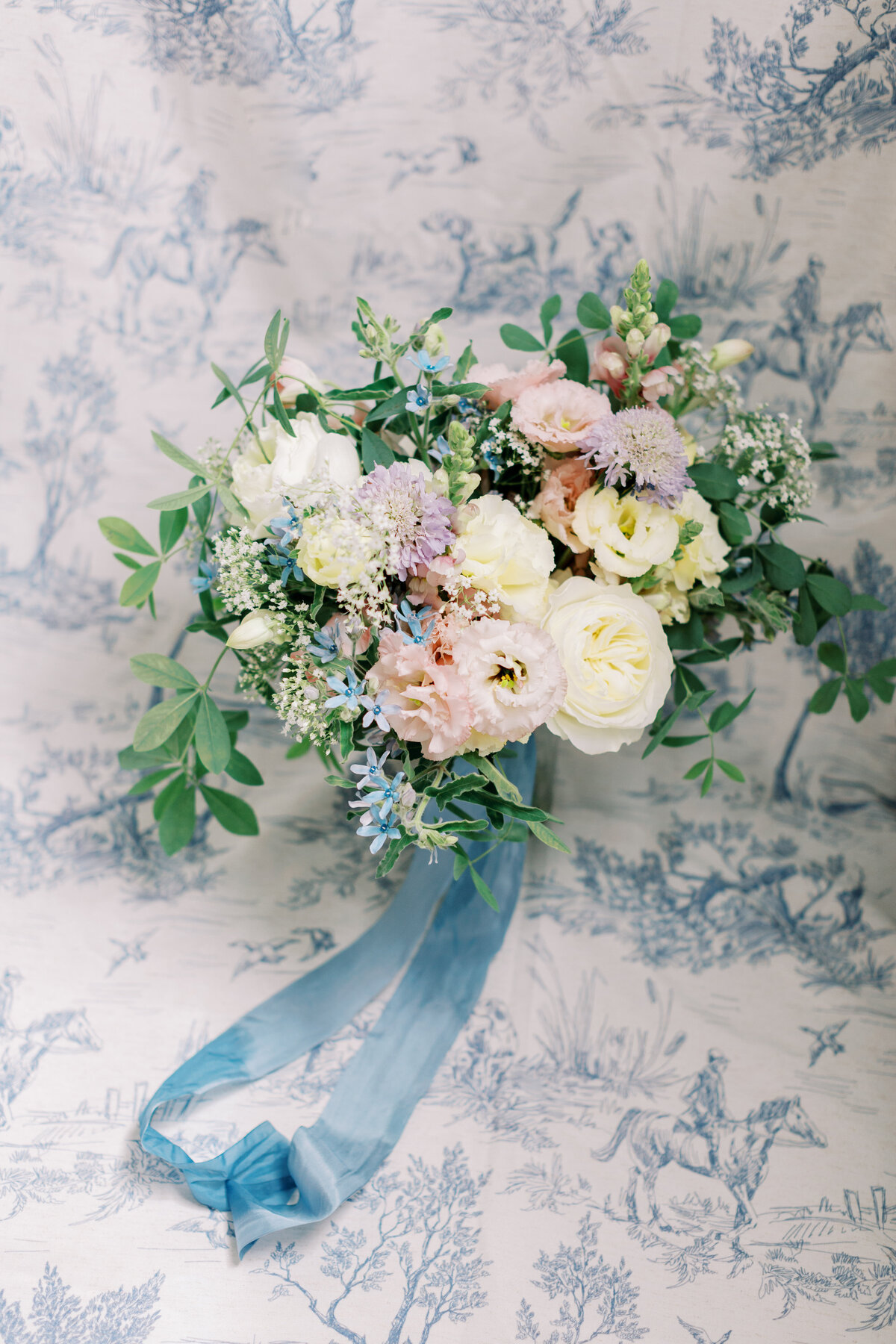 Graden styled bridal bouquet with long blue ribbon