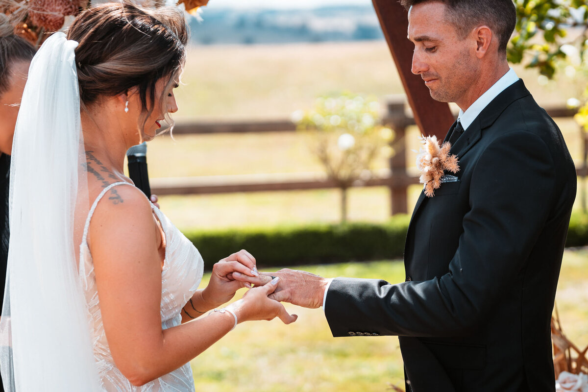 Mikaeley putting on his husband's wedding ring