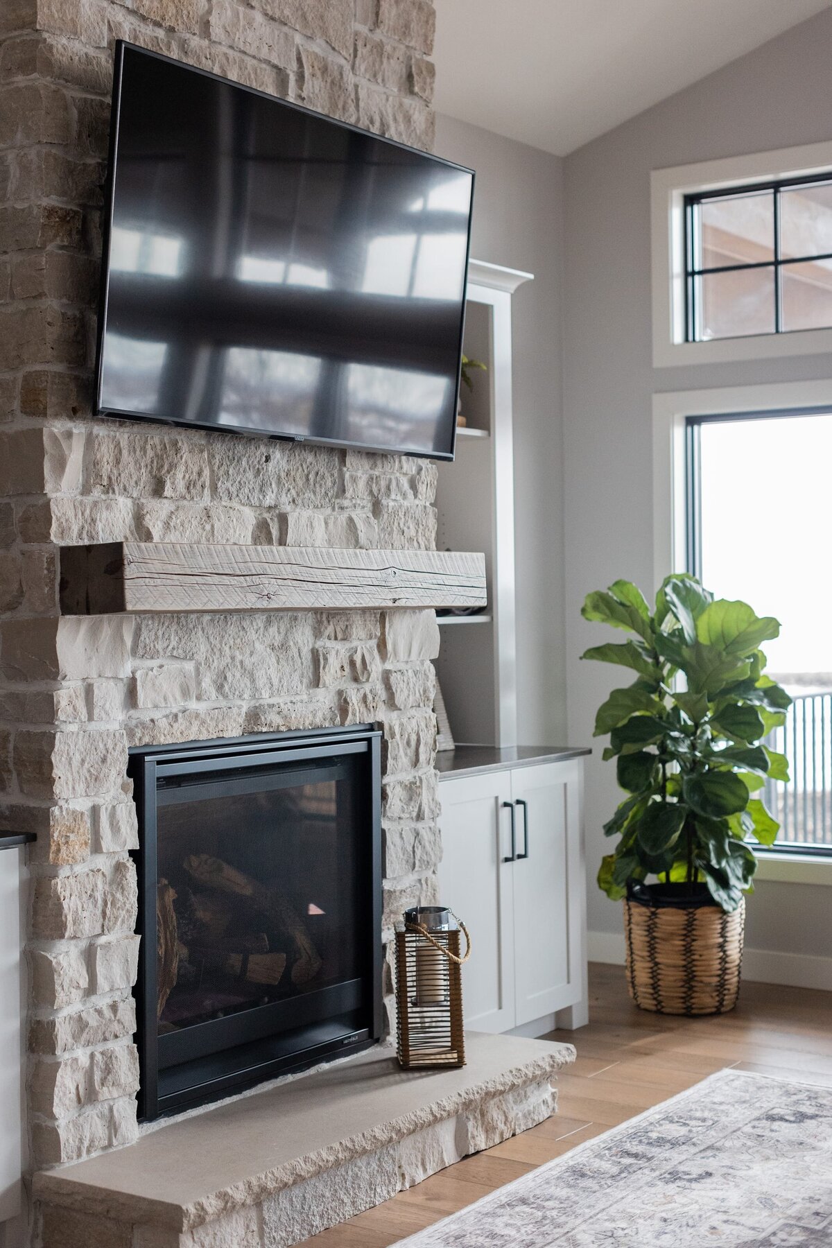 michele rosenboom design modern farmhouse stone fireplace with tv and wood mantel