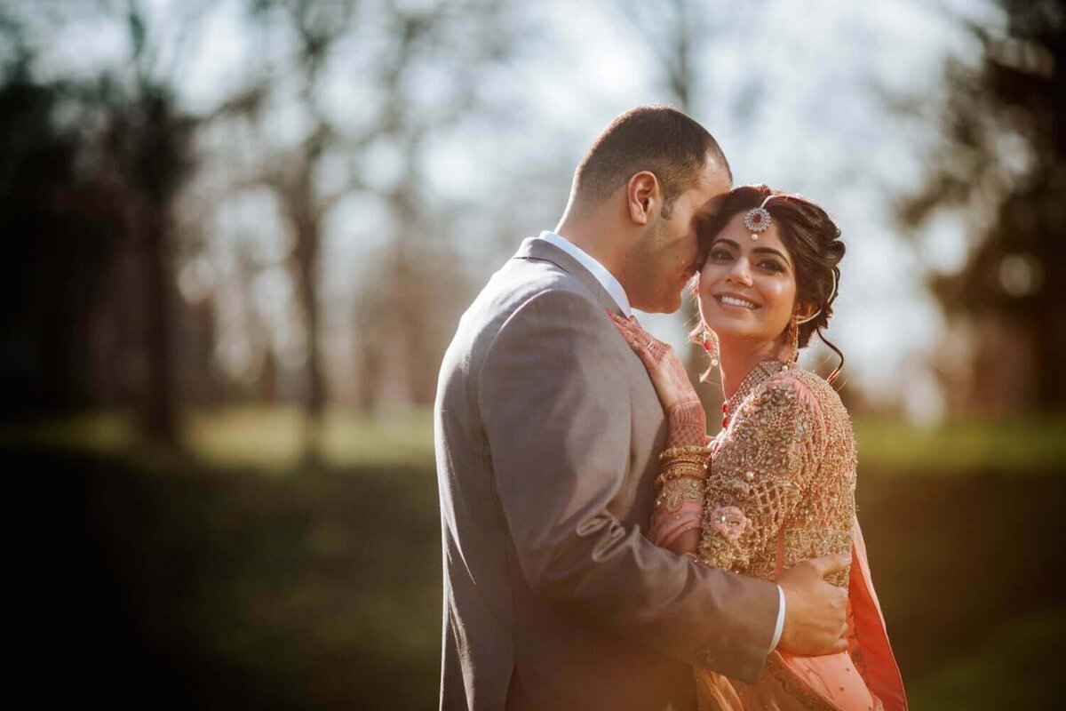 South Asian Bride and Groom hugging and embracing a moment of solitude.