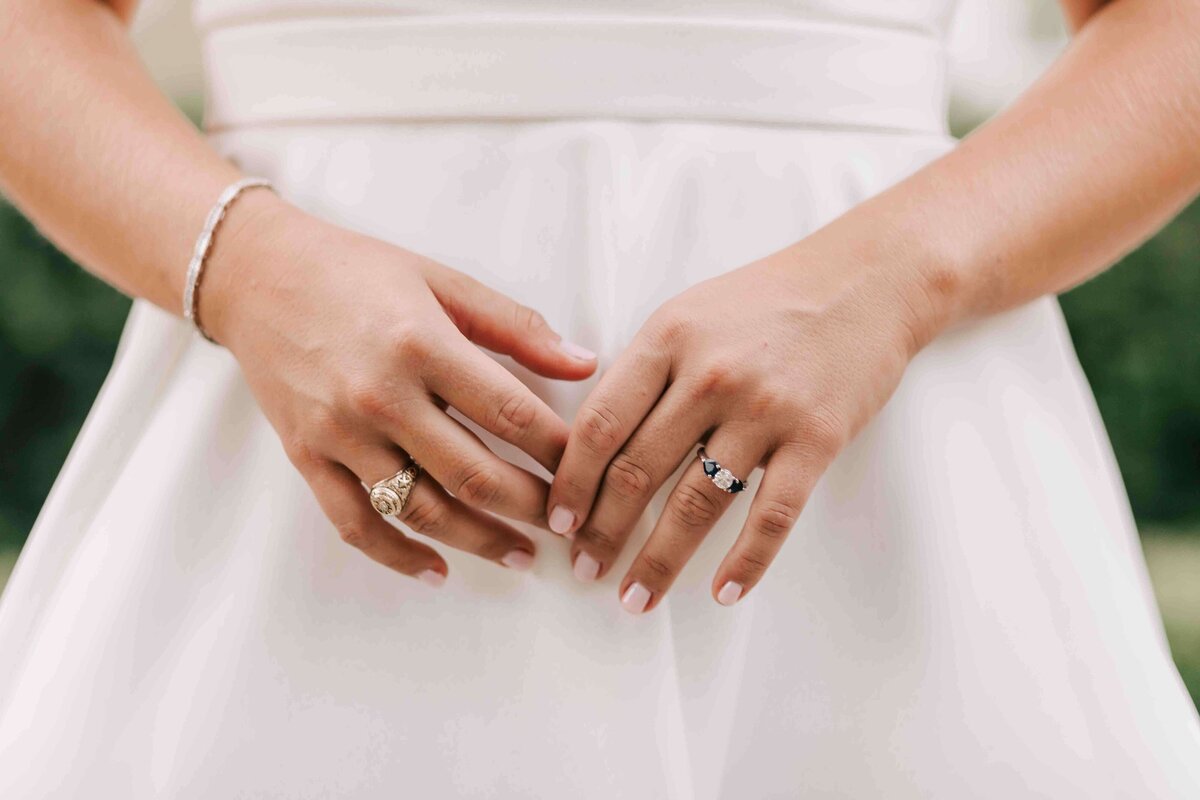 bride shows off her wedding ring and college ring