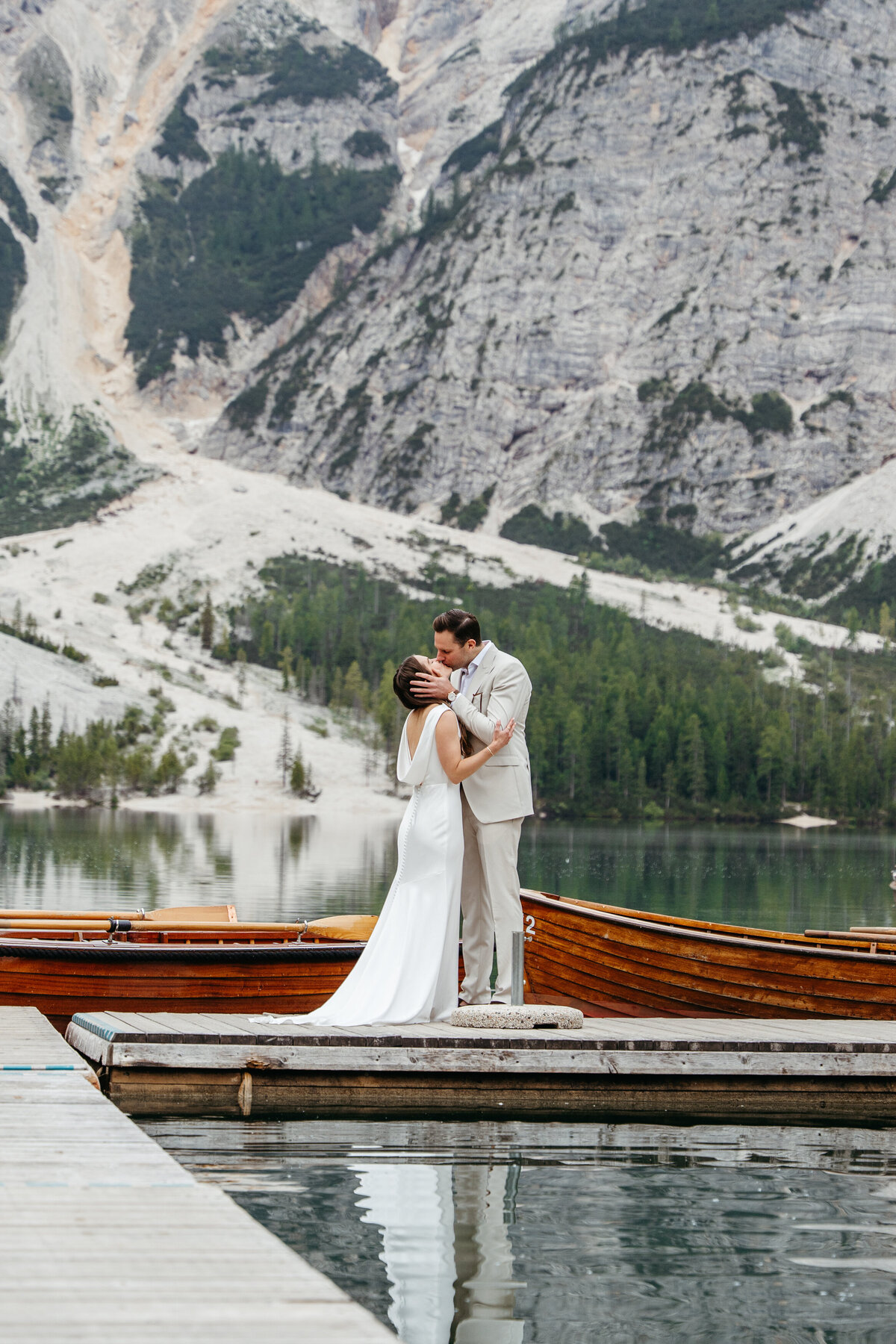 sweet couple romantic kissing dolomites lake Braies elopement