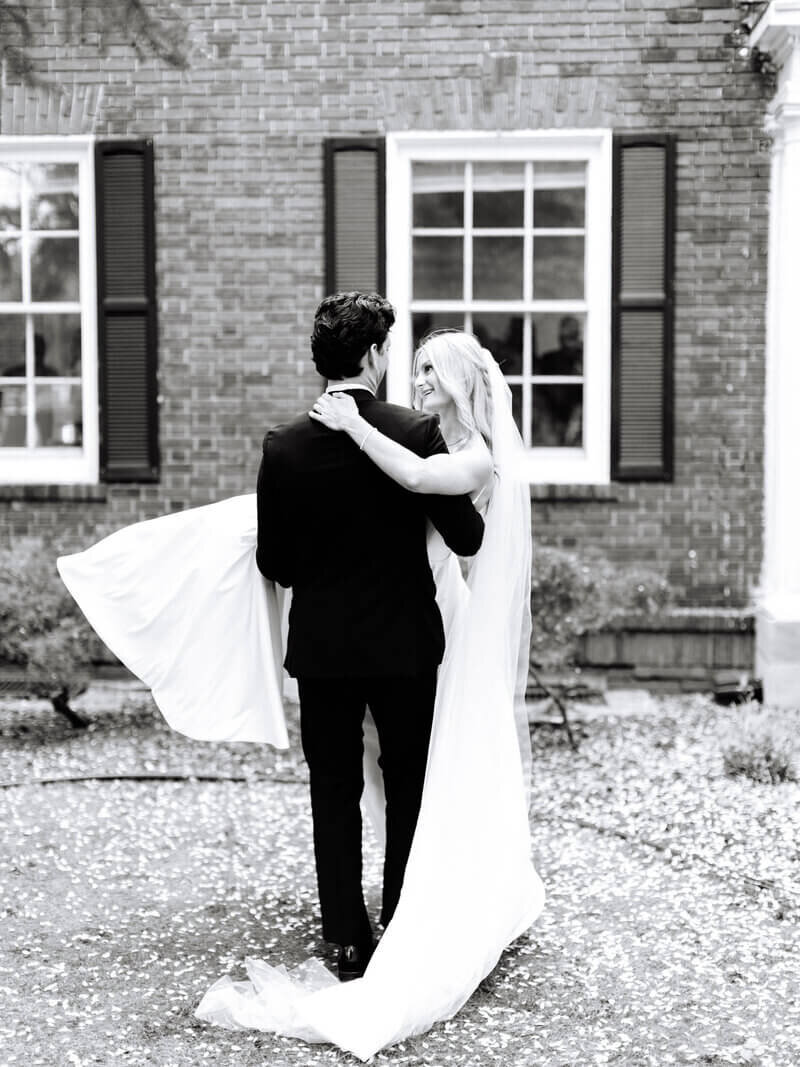 Groom holding bride and walking by wedding planners in chicago