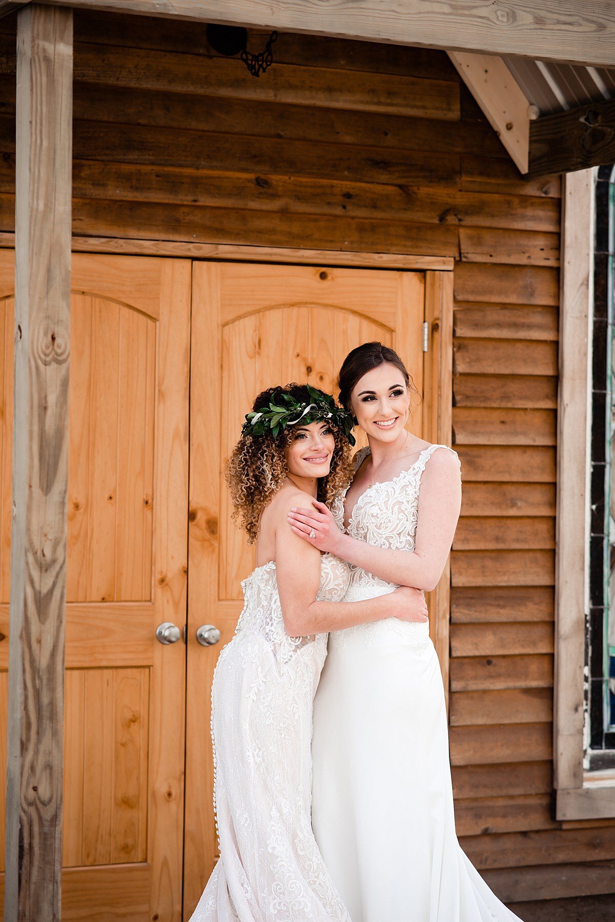 Brides eloping in front of a wooden cabin