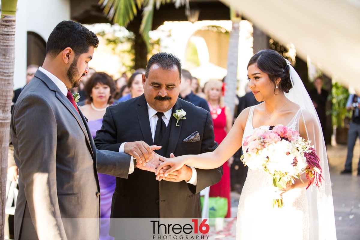 Bride's Father joins her hand with the Groom's hand