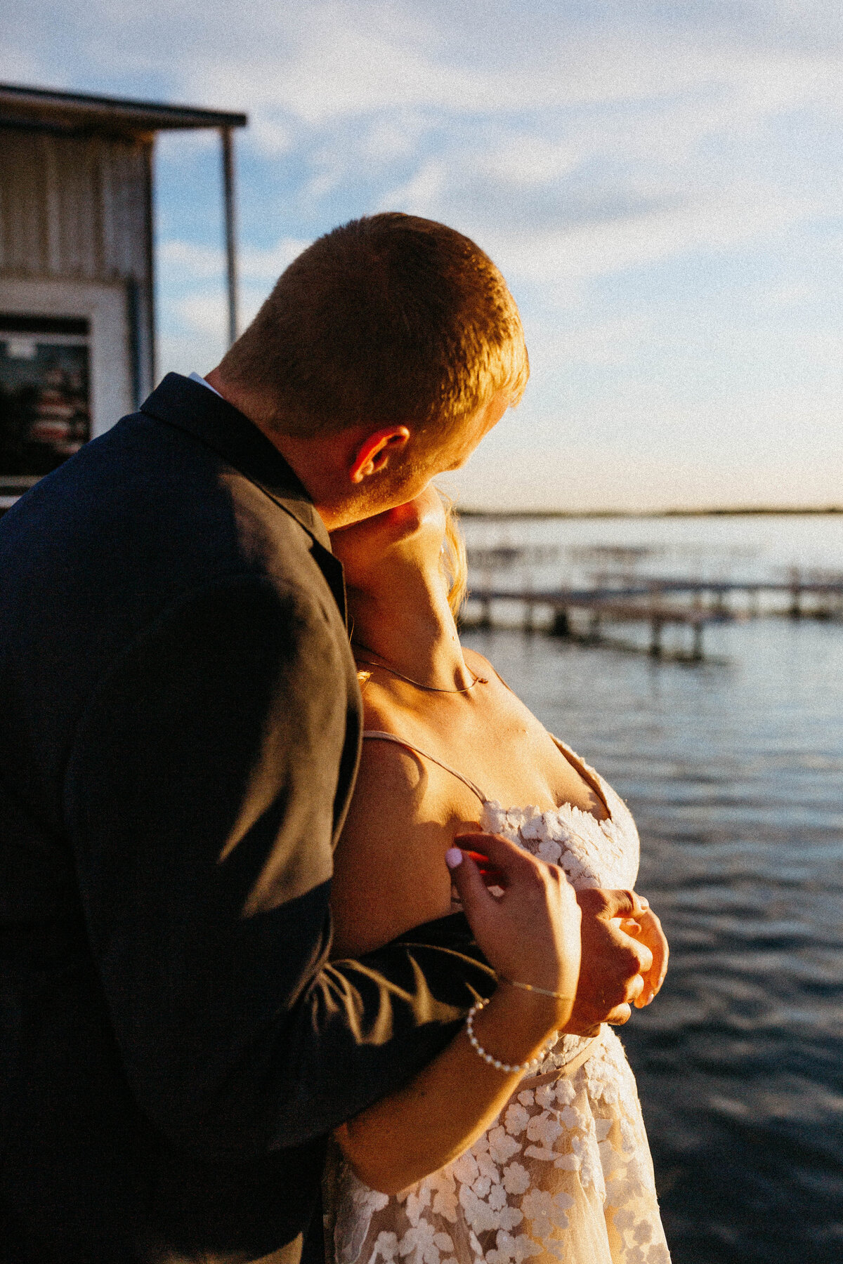 bride-kissing-groom-by-lake