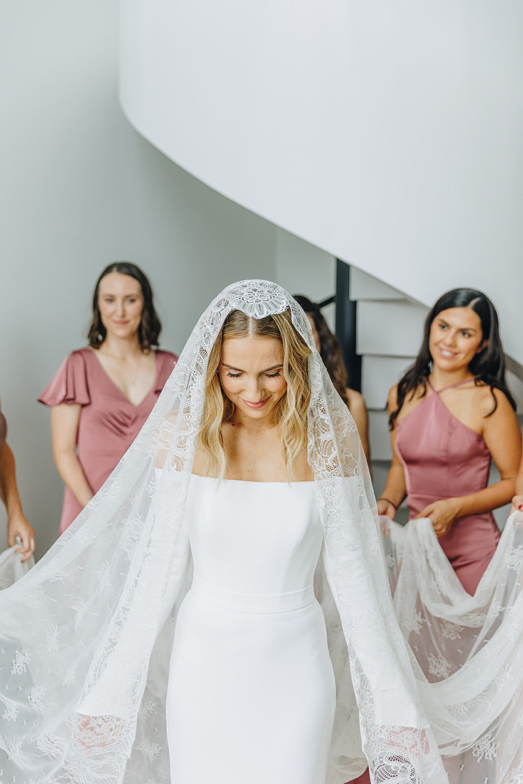 bridemaids holding bride's traditional veil in new york city 