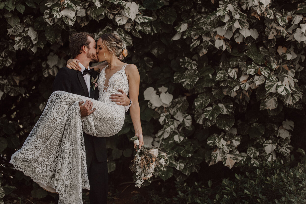 groom-holdling-bride-kissing-wearing-galia-lahav-wedding-dress