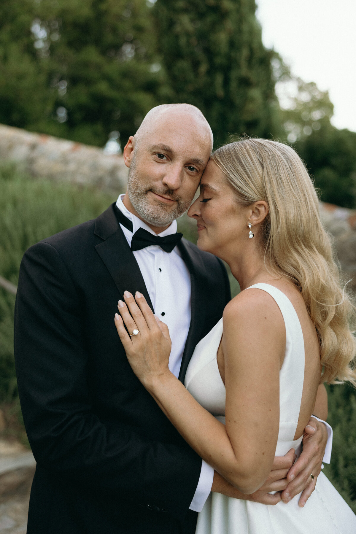 Bride and groom sharing a tender moment together, captured in a beautiful and intimate setting.