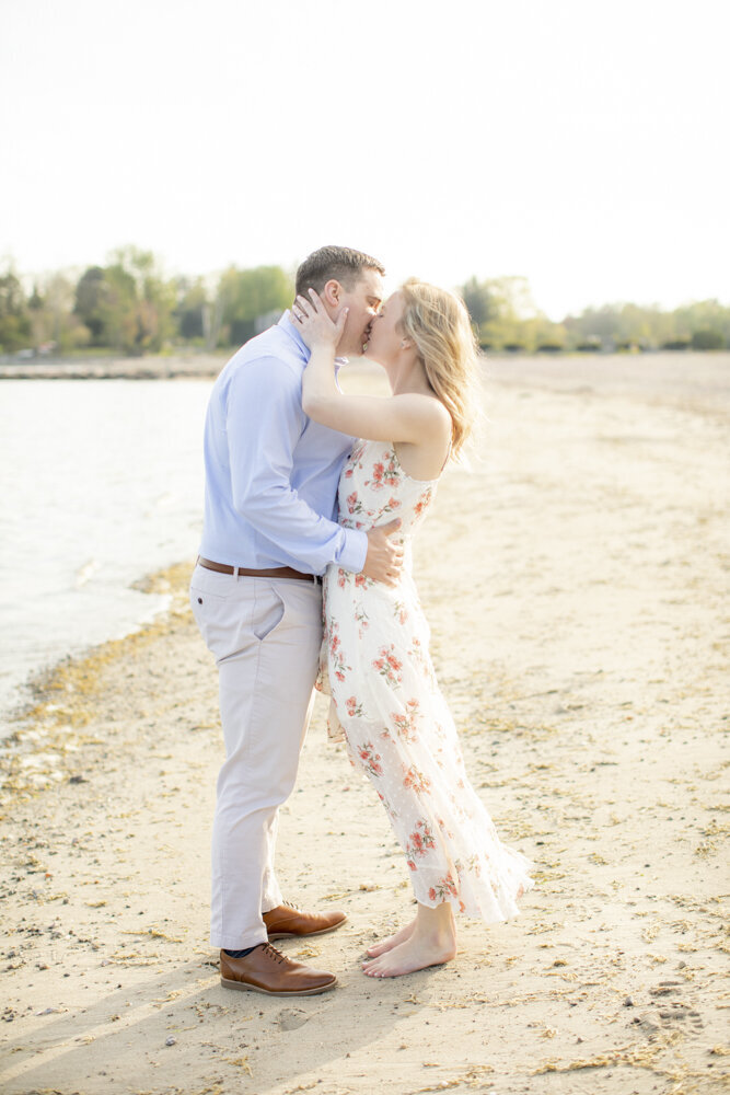 Southport CT engaged couple kissing on the beach